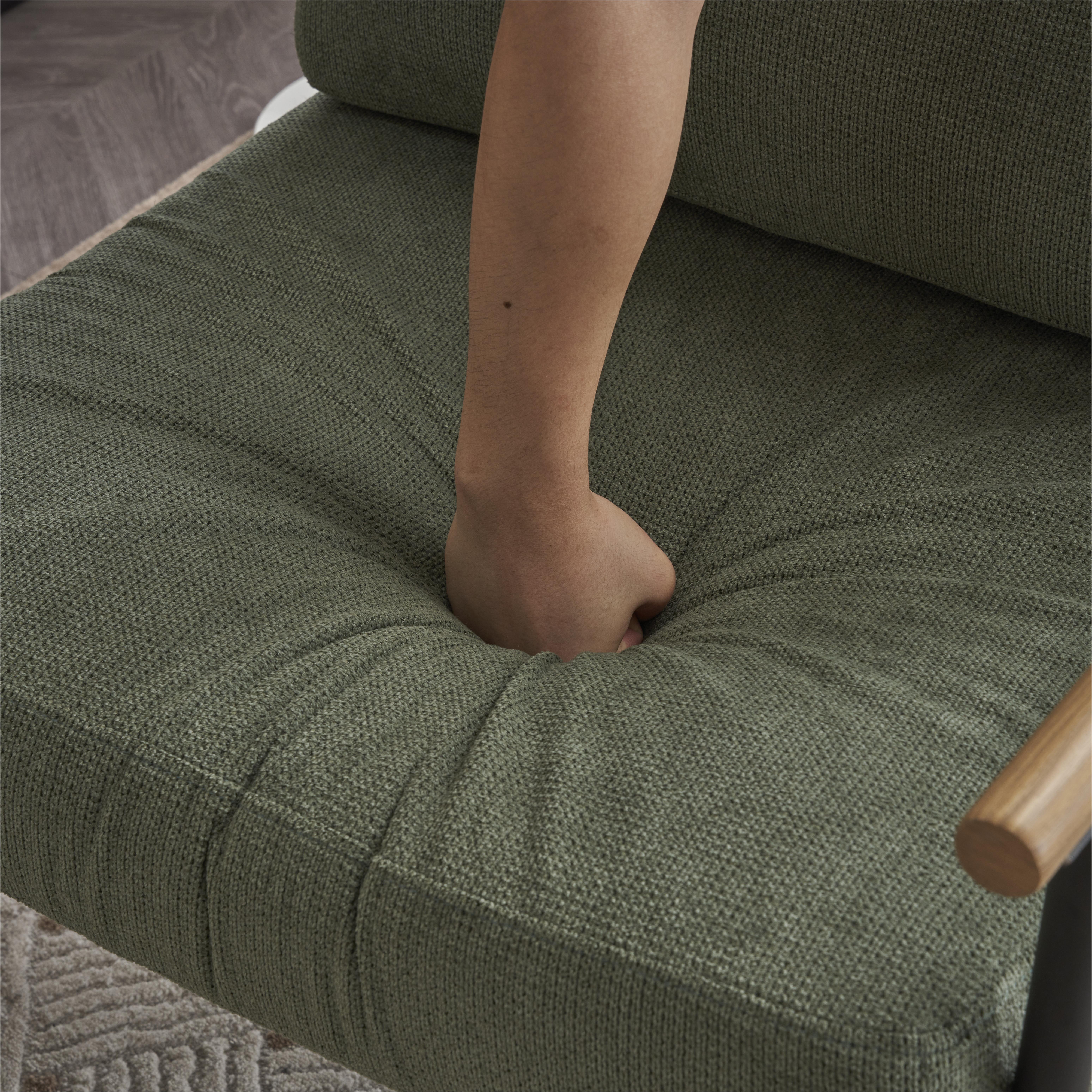 Hand pressing into soft padded chenille seat cushion