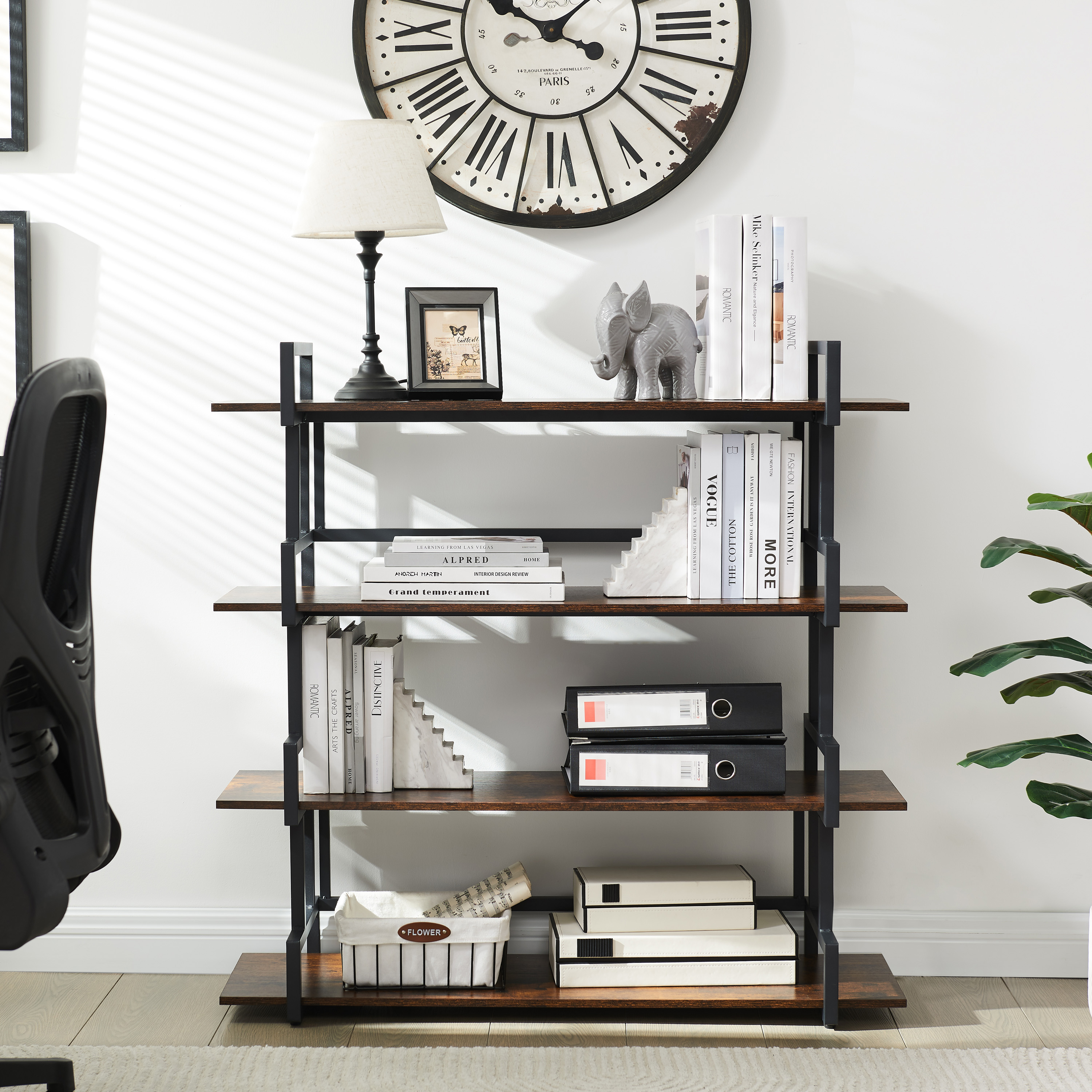 Office bookshelf holding books, binders, lamp and wall clock