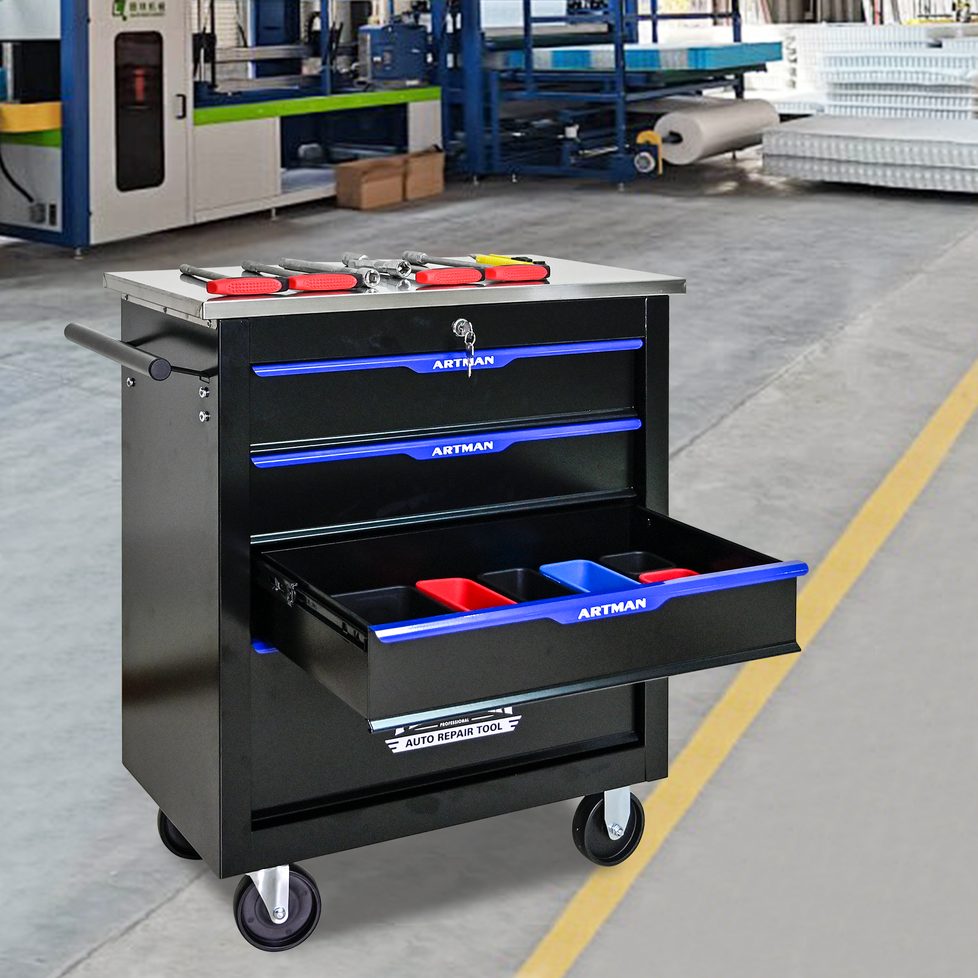 Open drawer with organizer trays and tools on a workshop cart
