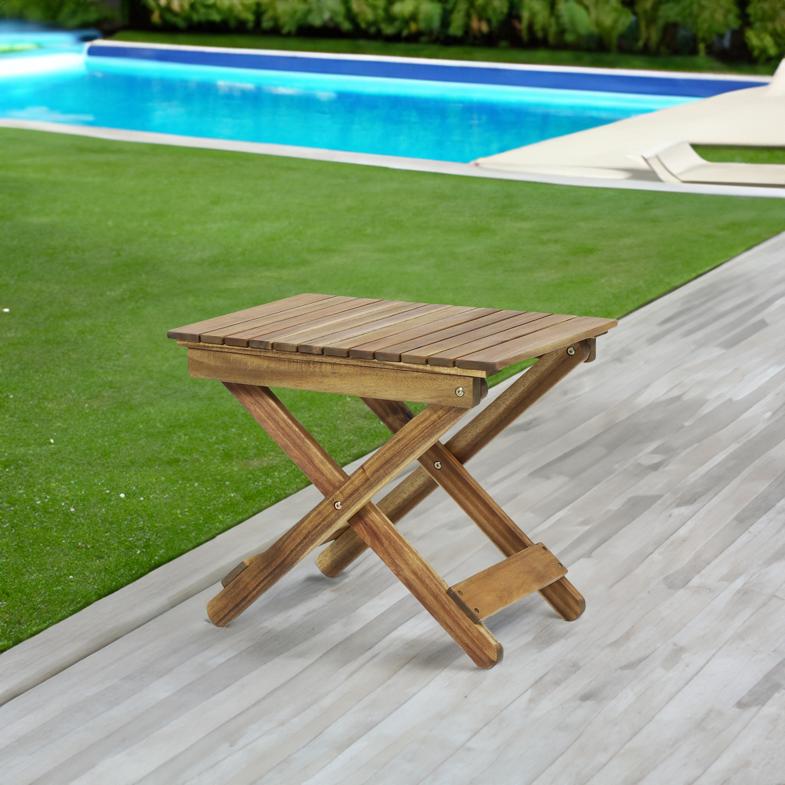 Wooden side table beside a pool deck and lawn