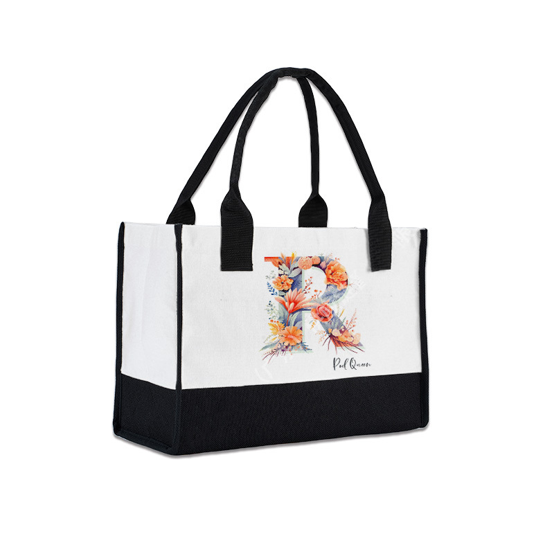 Custom colorblock handbag with floral "R" initial, crafted from linen cotton material.