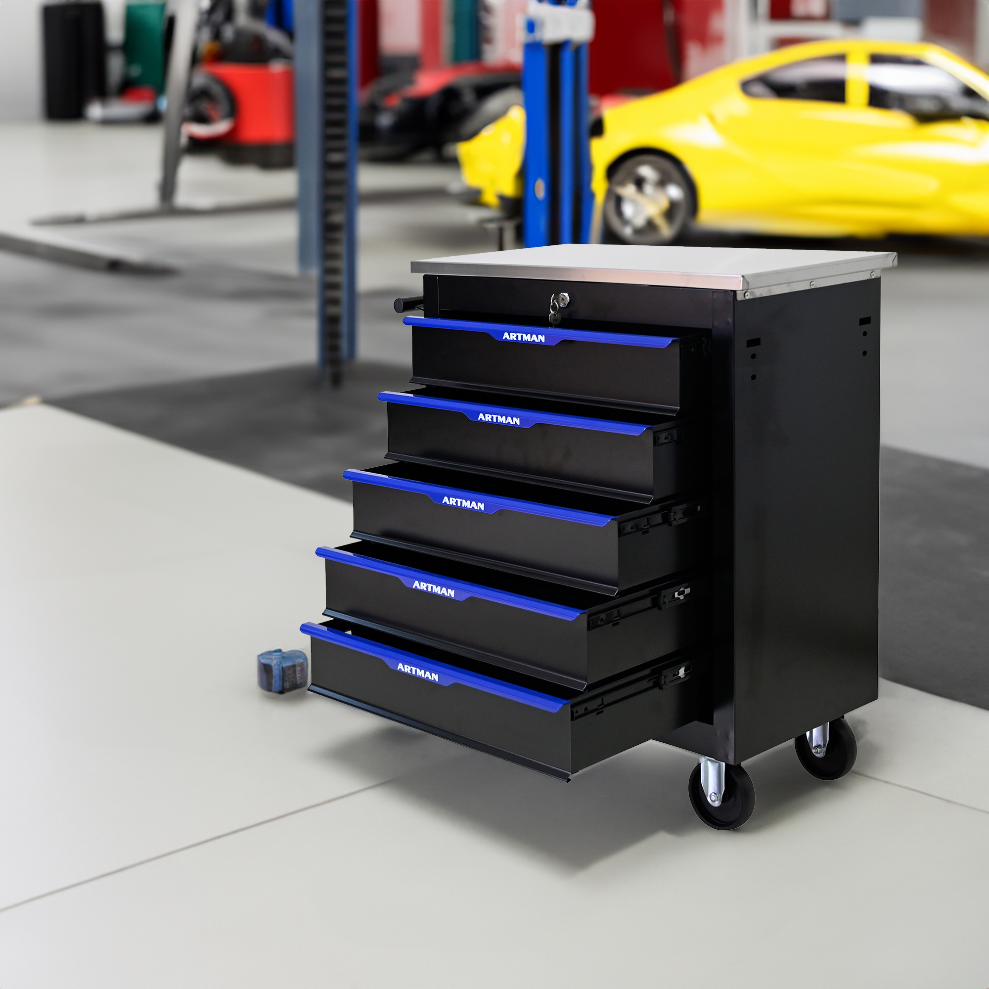 Open drawers on a tool cart in a busy auto shop