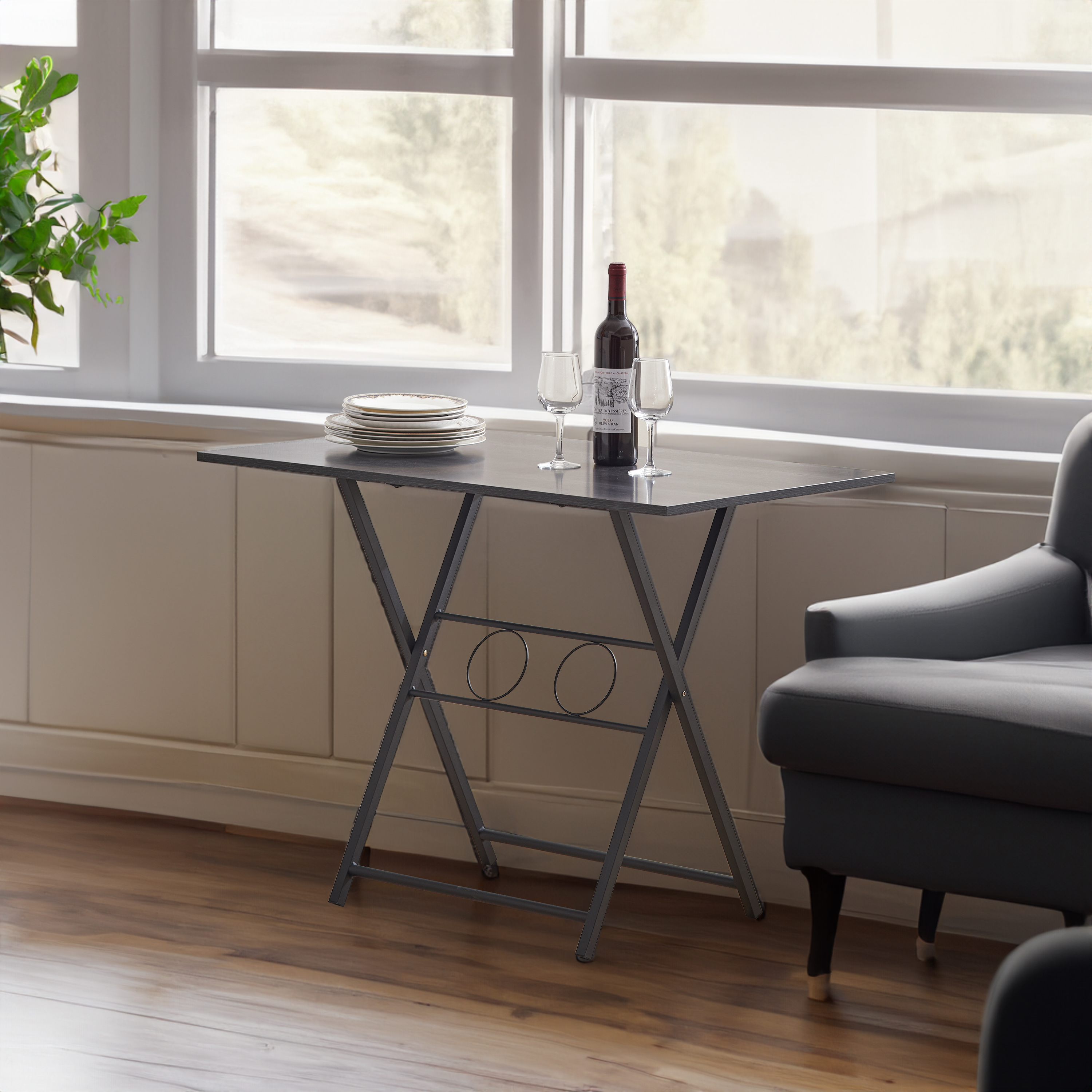 Foldable grey desk by a window set for dinner