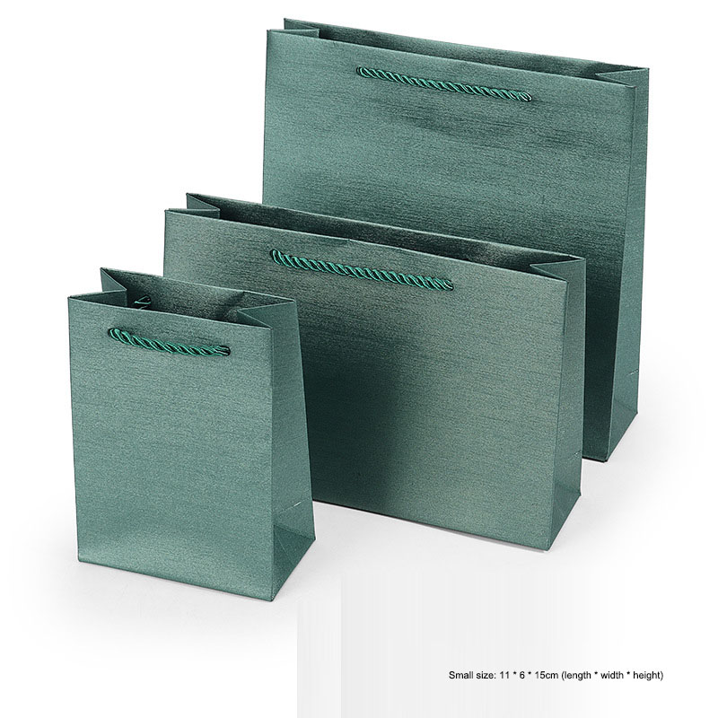 Forest sage brushed paper gift bags showing matte texture across the set
