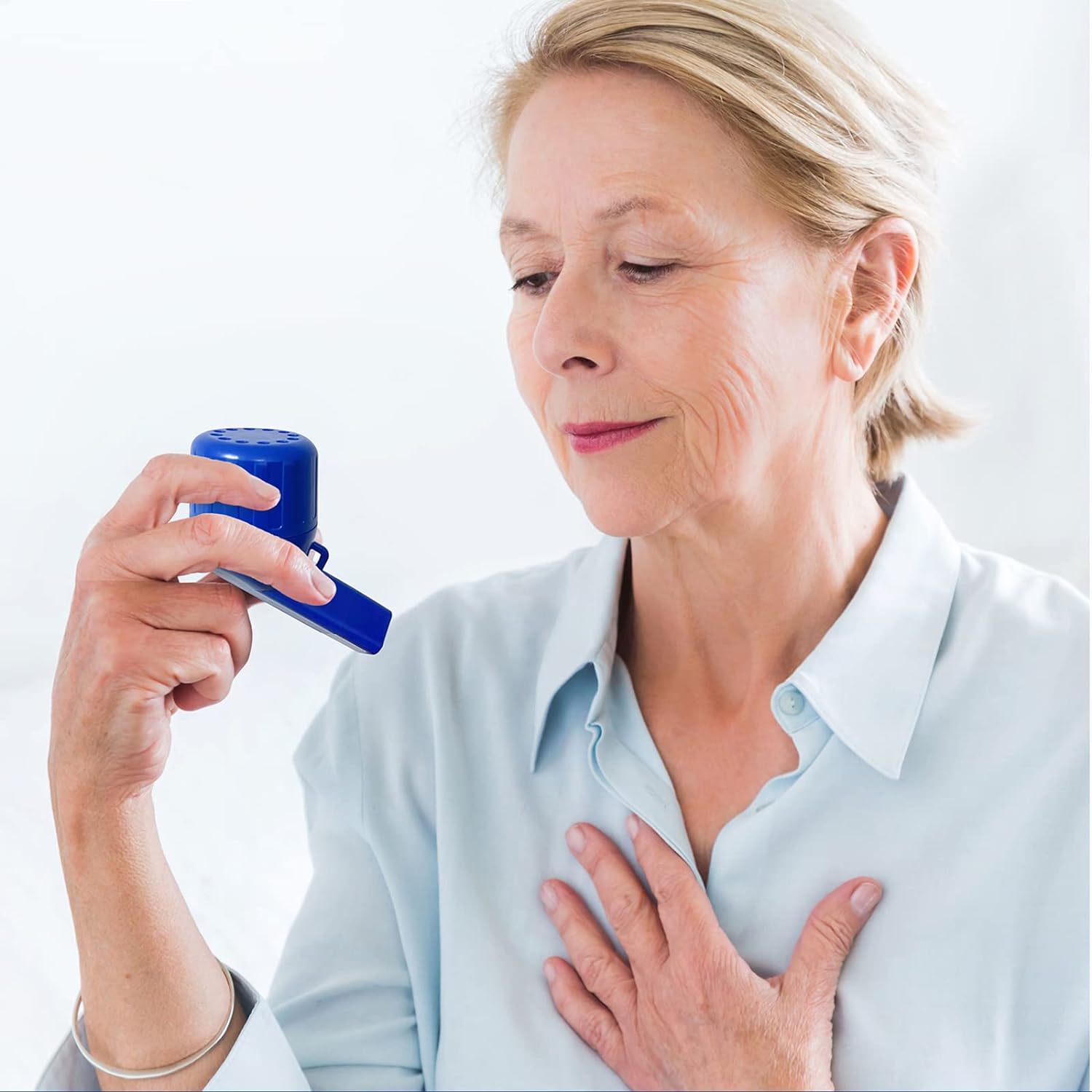 Mature woman comfortably using the lung exerciser at home, showing regained confidence and ease