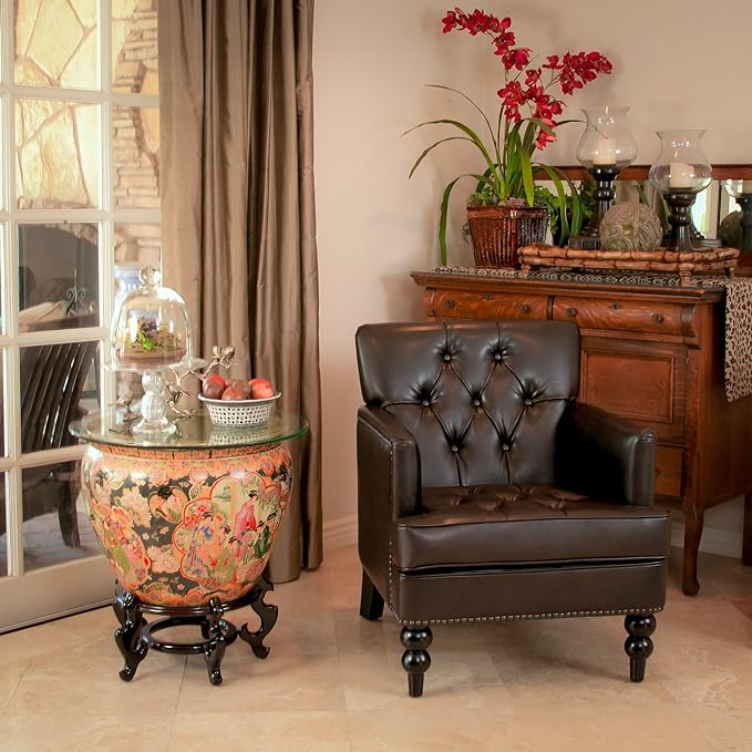 Brown tufted chair beside a traditional wood sideboard and side table