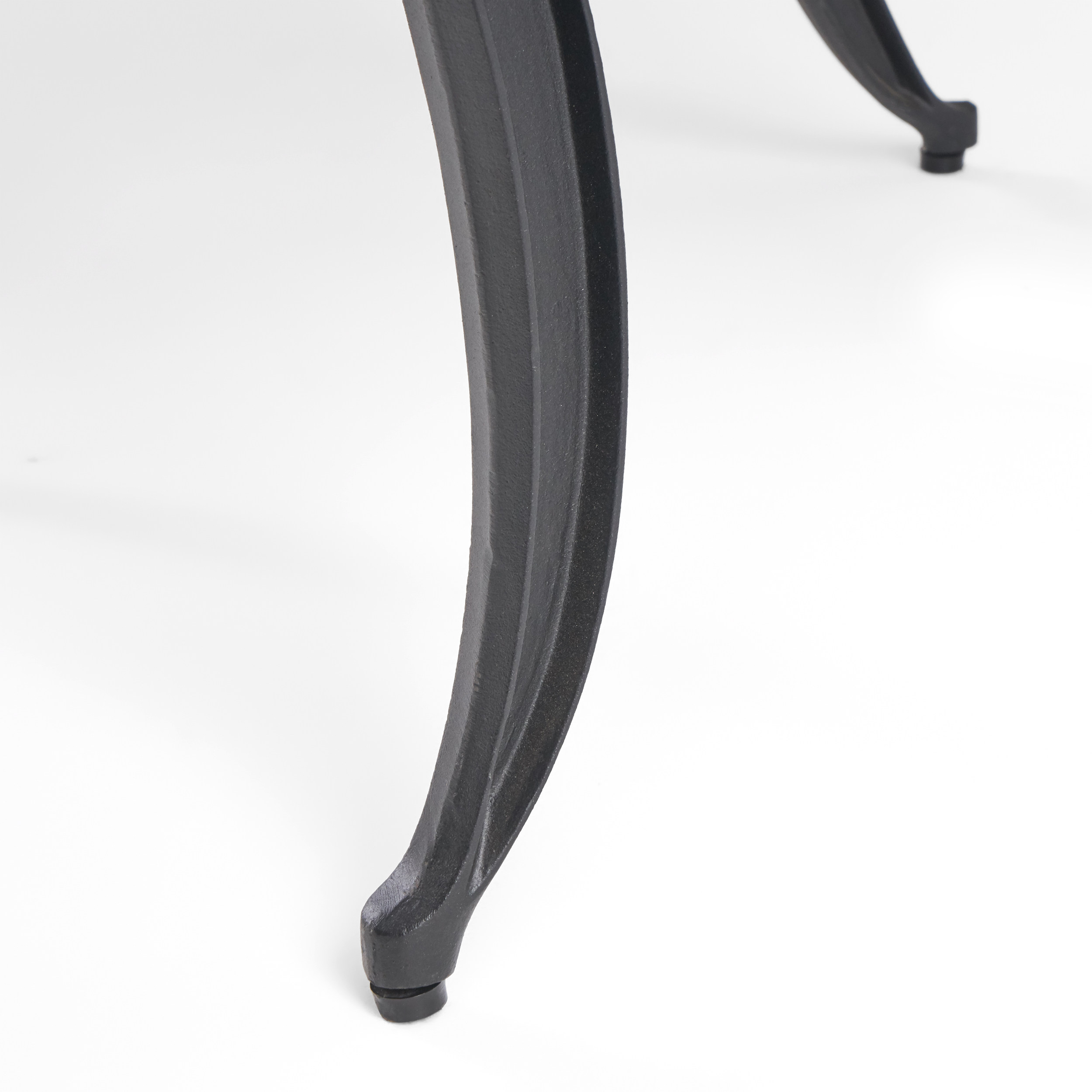 Close-up of a curved cast leg with rubber foot cap