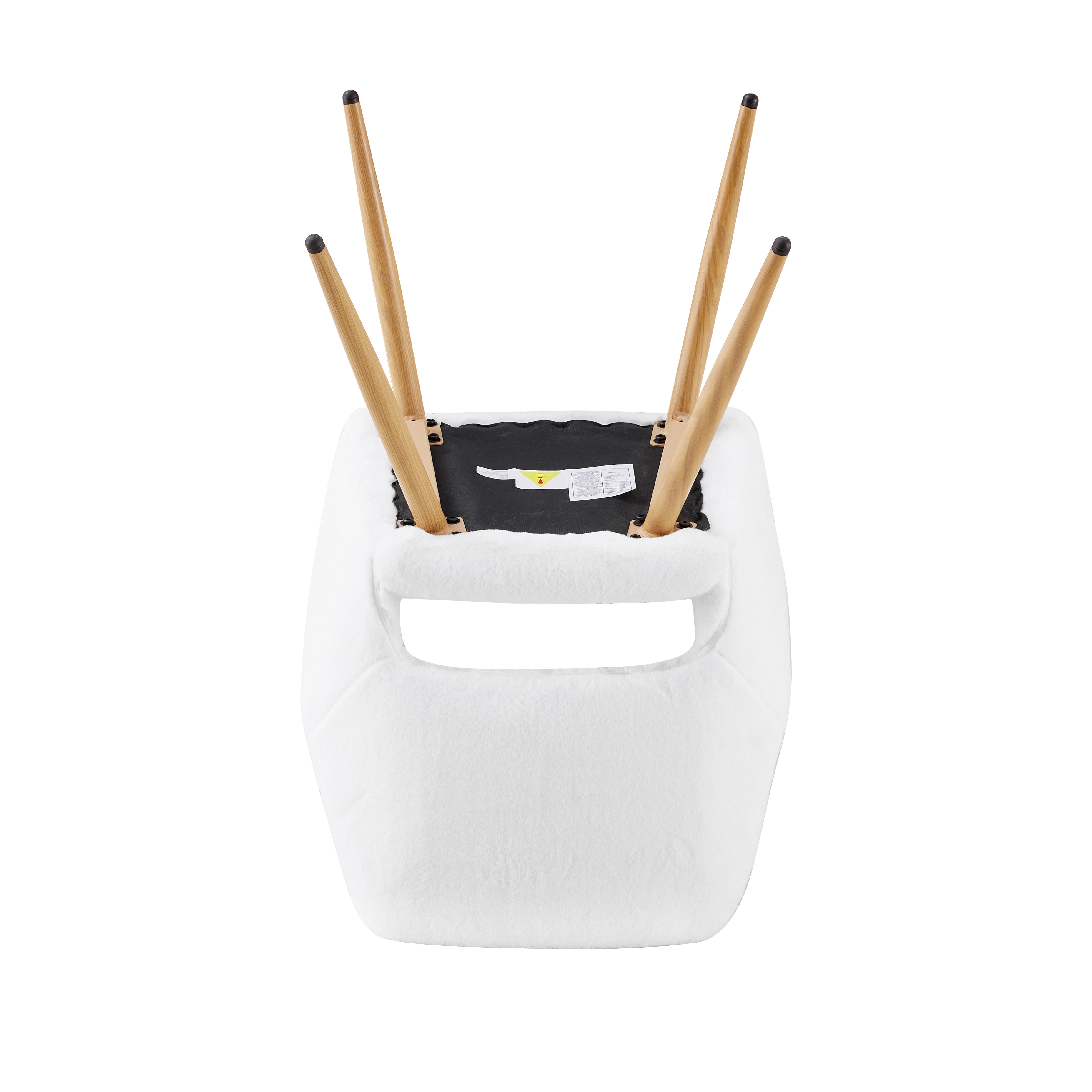 Armchair with cut-out back and curved armrests against a light backdrop