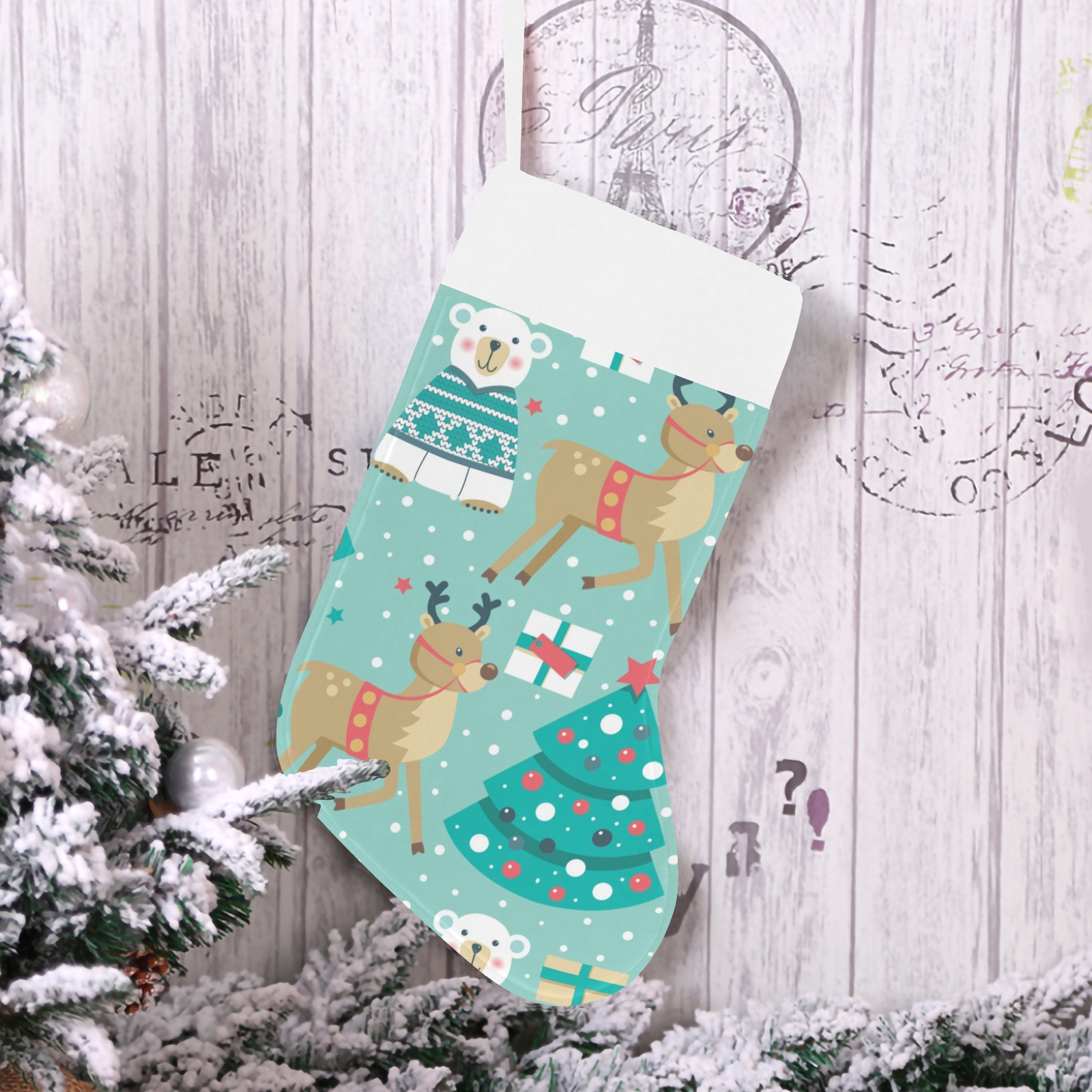 USA-made Christmas stocking with reindeer, snowman, and Christmas tree pattern, hanging on a decorated branch.