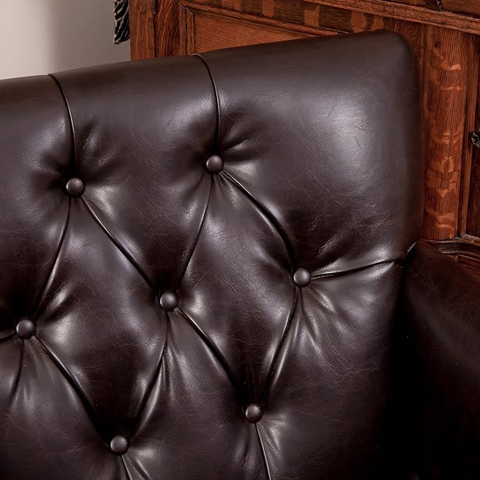 Close-up of diamond button tufting on a brown faux leather high back
