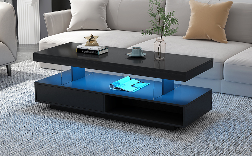 Black LED coffee table glowing blue in a softly lit evening room