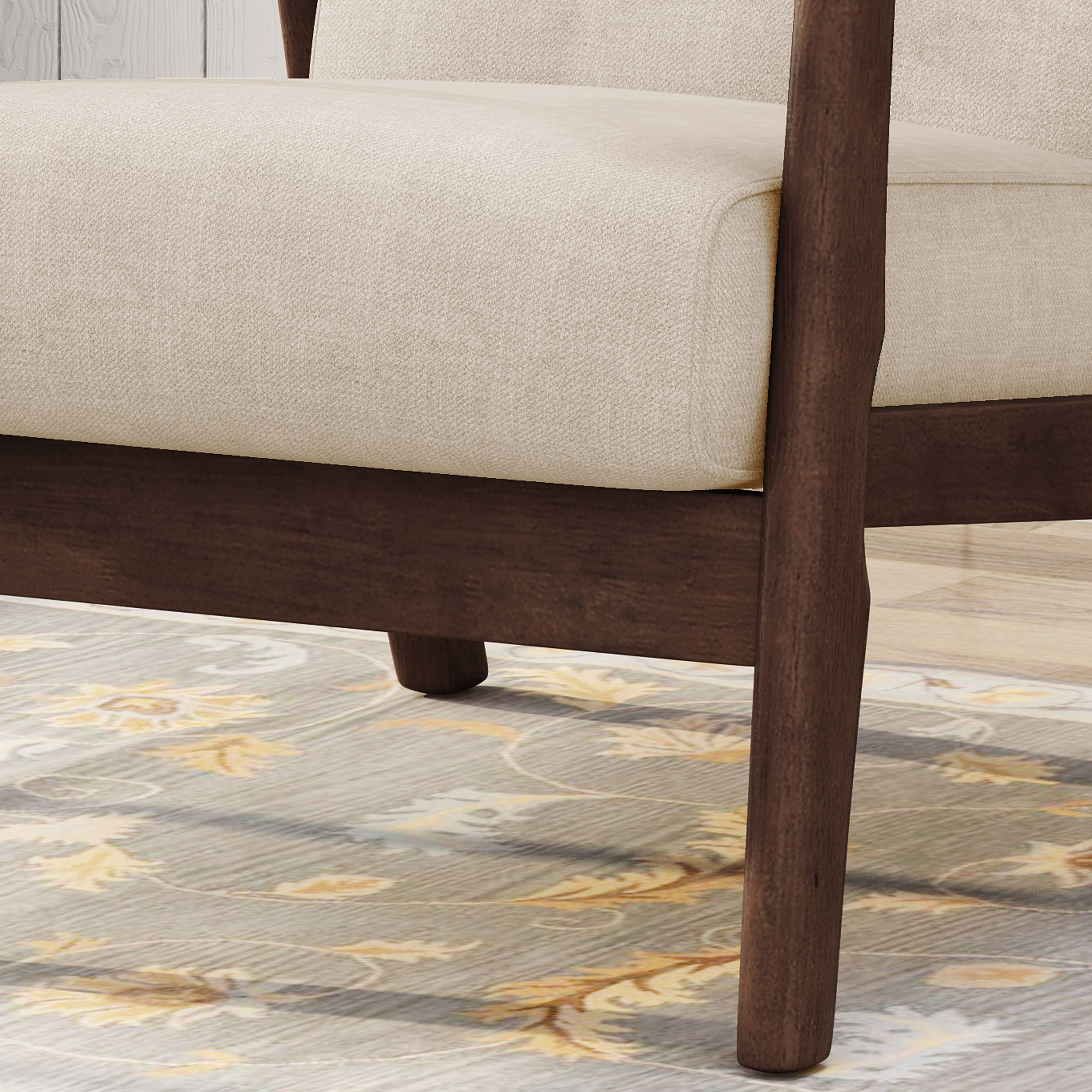 Close-up of beige upholstered seat and walnut wood leg on a rug