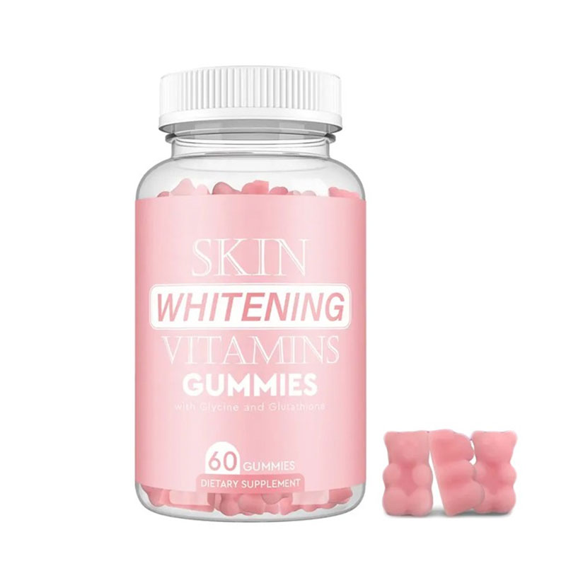 Pink glass bottle of Skin Whitening Vitamins Gummies with white screw cap, filled with pink gummy bears, alongside loose gummy samples