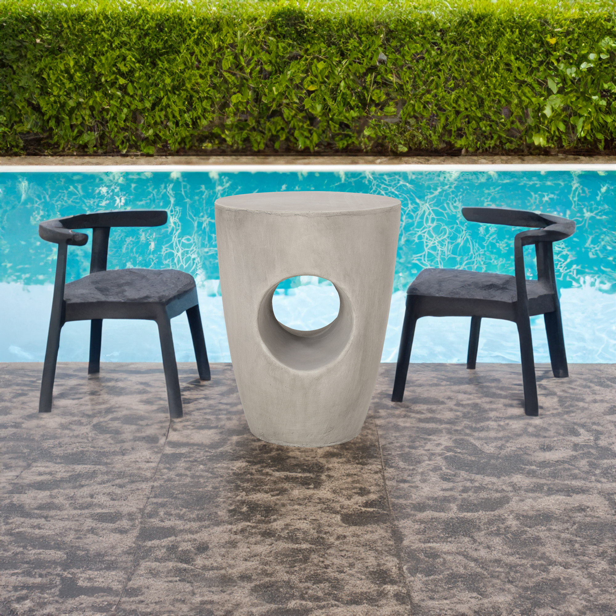 Lounge chairs by a pool with nowhere to set a drink nearby