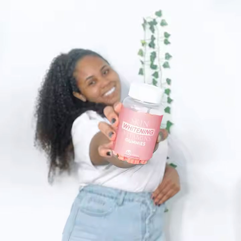 Young woman holding the gummy bottle, enjoying the tasty daily ritual of skin care