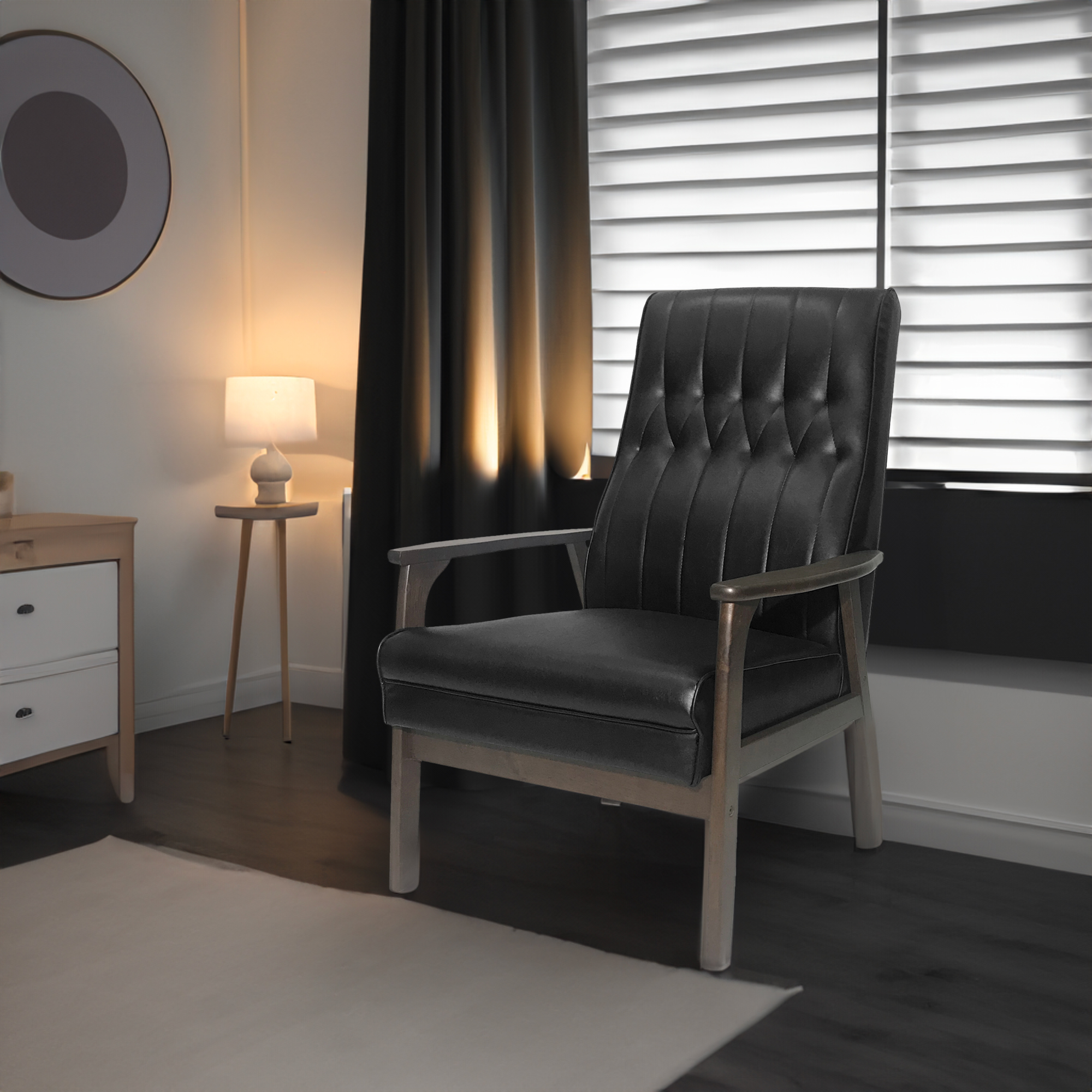Black tufted accent chair in a dim bedroom beside a warm table lamp