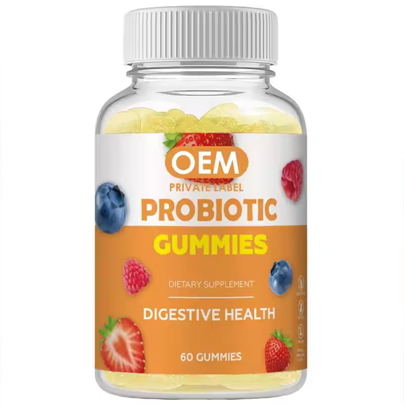 Clear glass jar of vibrant fruit-shaped probiotic gummies with white ribbed cap on pale celadon ceramic surface, surrounded by fresh mint leaves under soft morning light