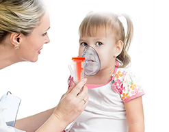 Child receiving nebulizer treatment with caregiver assistance, warm afternoon light, visible mist generation