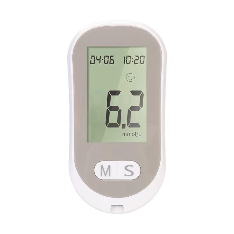 Close-up of glucose meter display showing 6.2 mmol/L, timestamp and smiley face indicator on light background