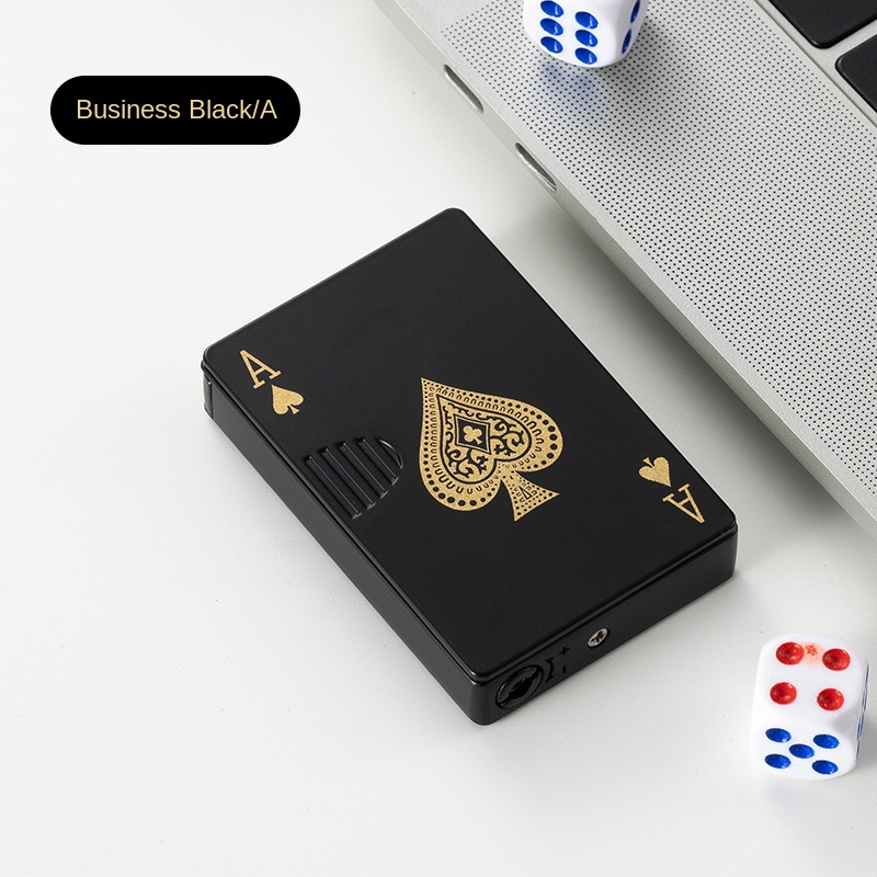 Plain lighter lying on a breezy outdoor table among playing cards