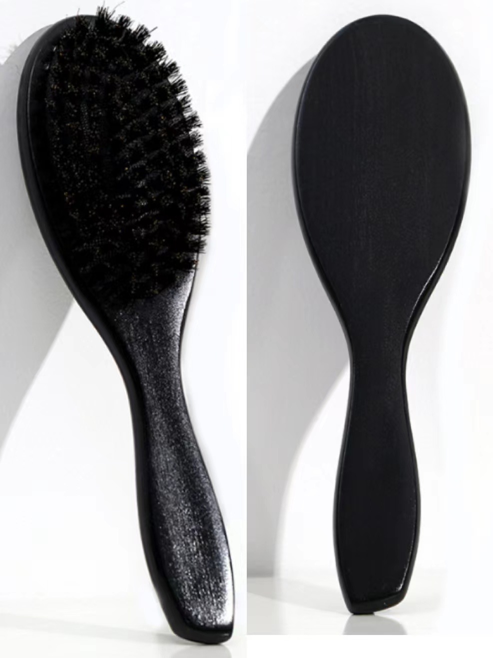 Two black wave brushes showing dense bristles and smooth backs