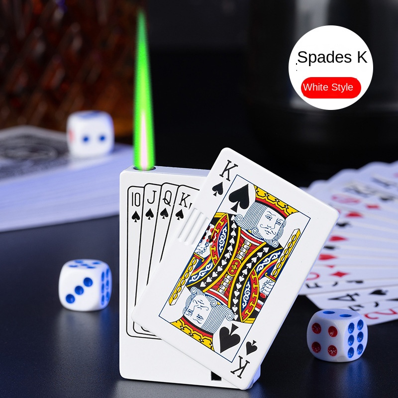Hand holding gold playing-card lighter at a poker table at dusk