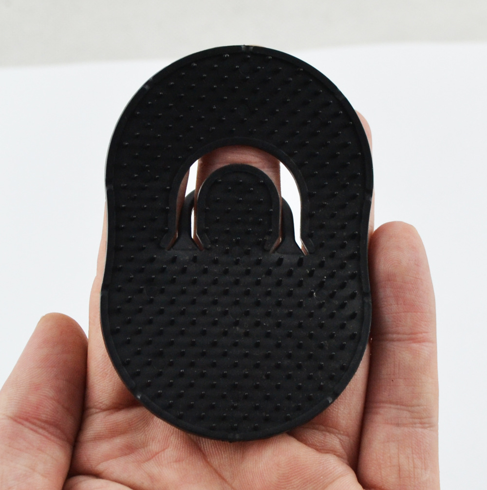 Hand holding compact wave brush for textured hair grooming