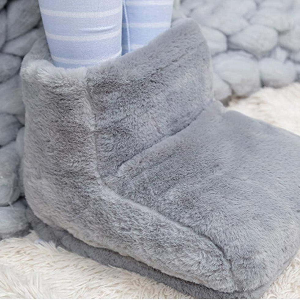 Legs in striped pajamas resting in grey foot warmer on a knitted blanket