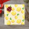Lemon pattern gift wrapping paper with red bow, perfect for birthday gifts