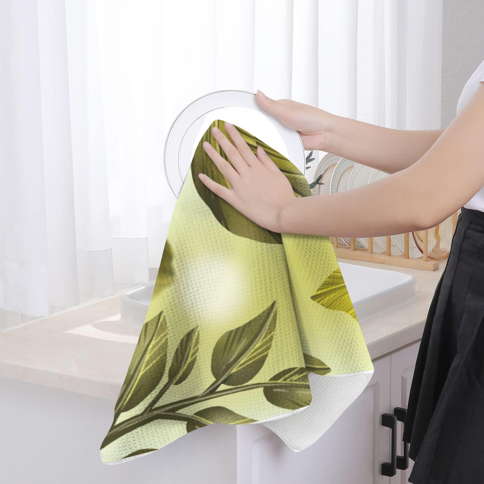 Soft, absorbent USA-made kitchen hand towel with green leaf design, ideal for wiping dishes.