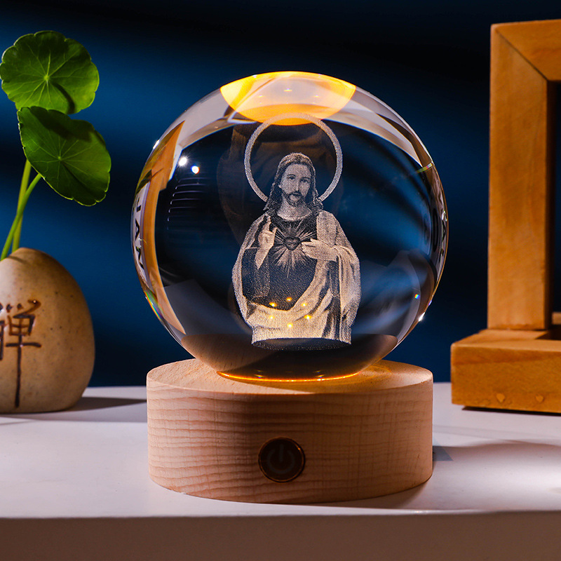 Engraved crystal sphere with halo glowing on a wooden base