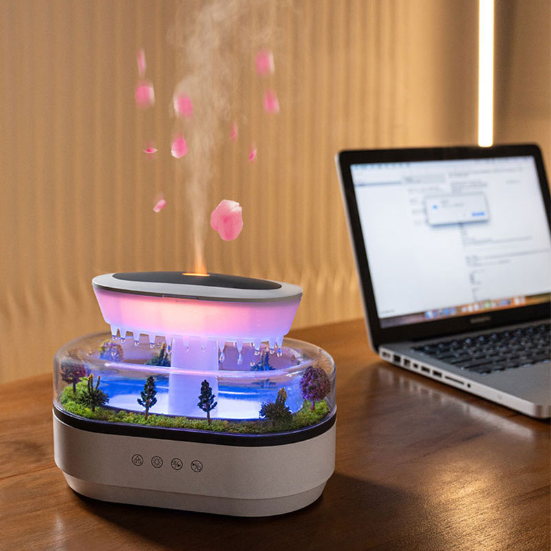 Desk humidifier glowing pink beside a laptop with warm wall light