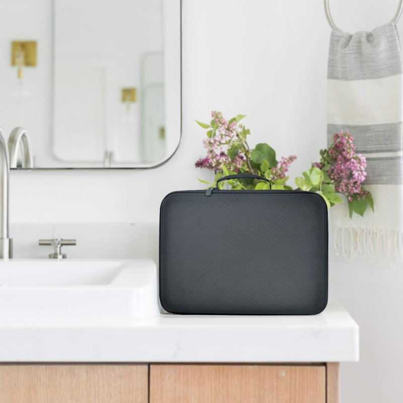 Black storage case on a bathroom vanity beside a hand towel