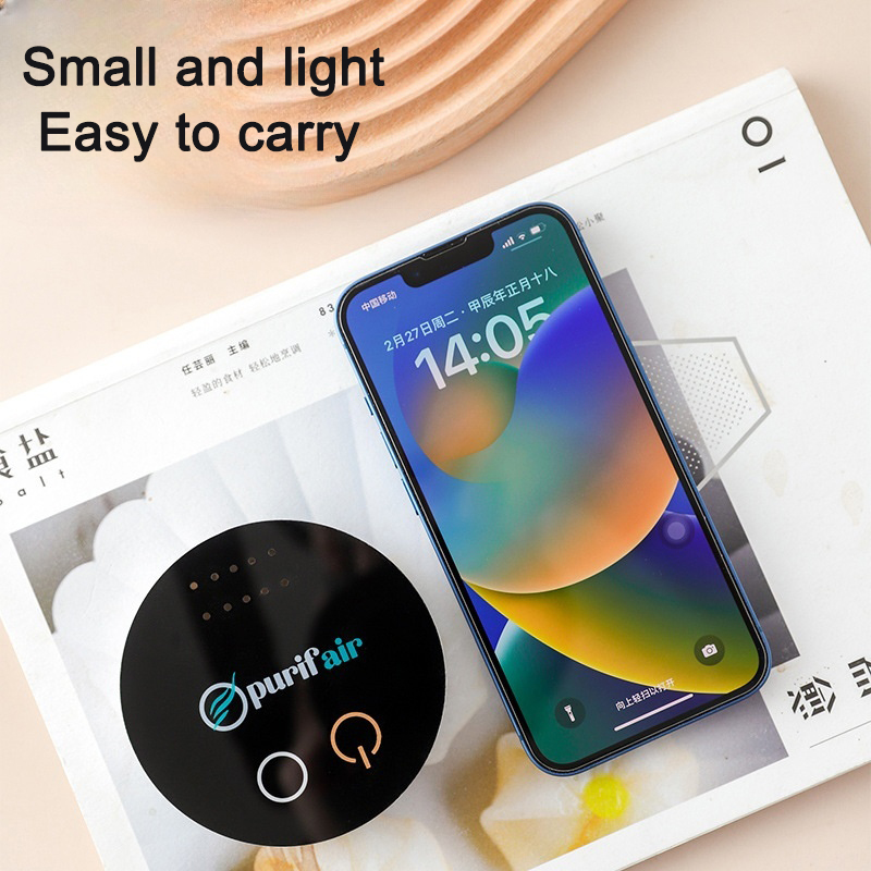 Small round purifier beside a smartphone showing its compact size