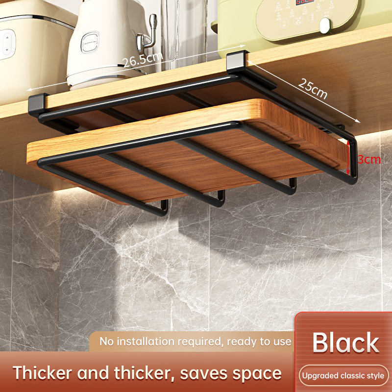 Wood cutting boards leaning in a rack under a kitchen cabinet