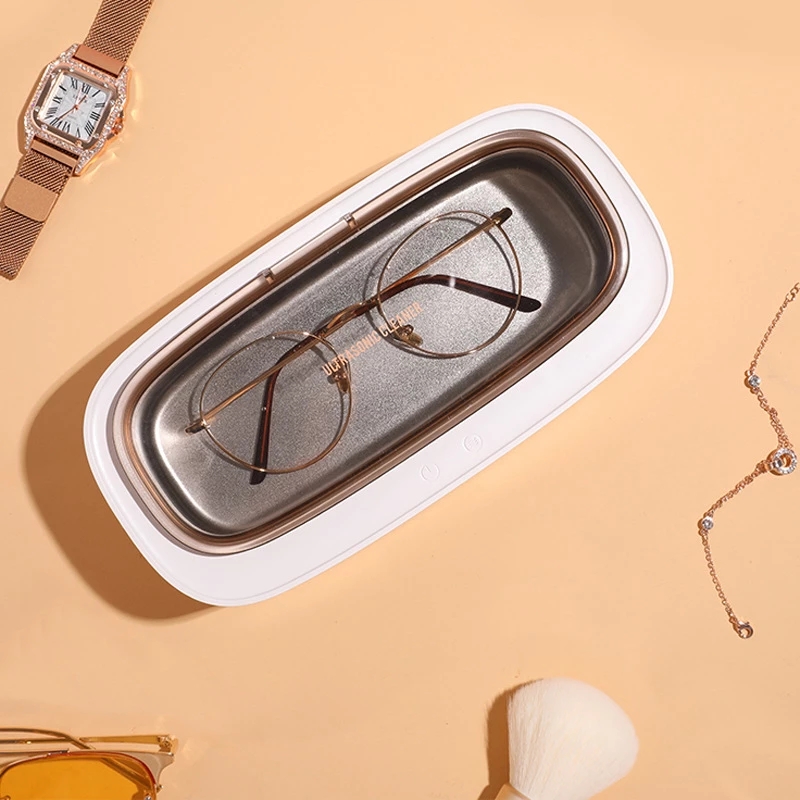 Eyeglasses, a watch and a bracelet resting in the steel tank