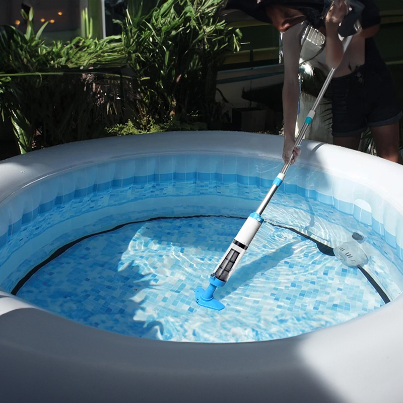 Cordless vacuum dipping into clear pool water, debris being suctioned into transparent chamber