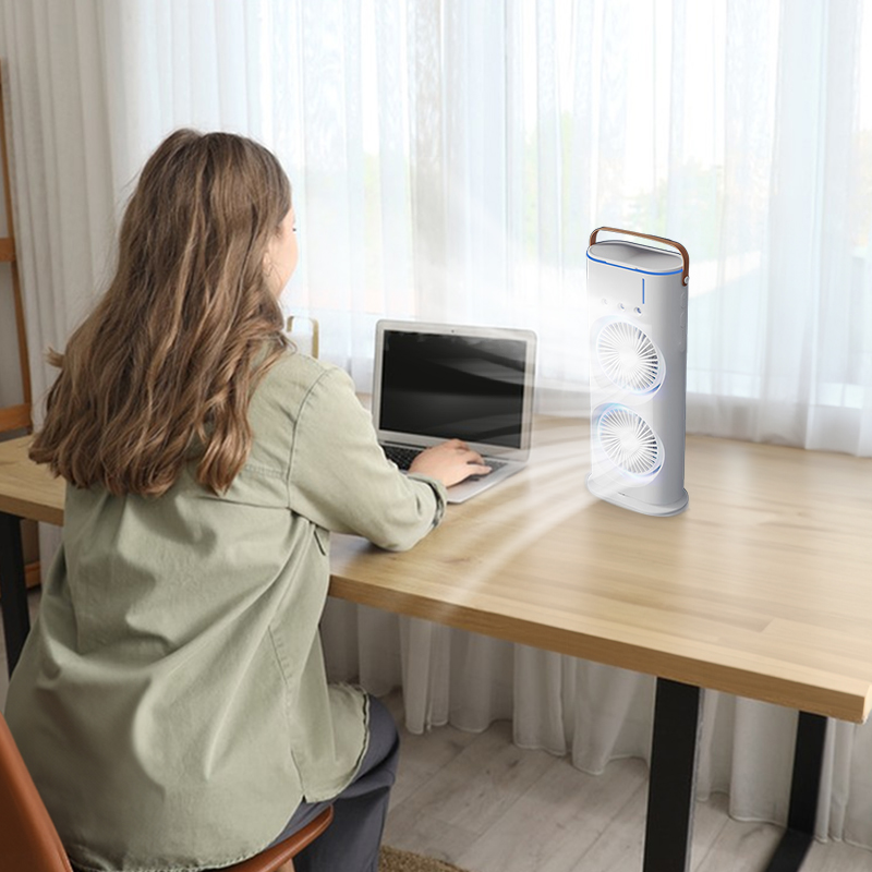 Woman at a wooden desk with the white twin-fan cooler beside her laptop