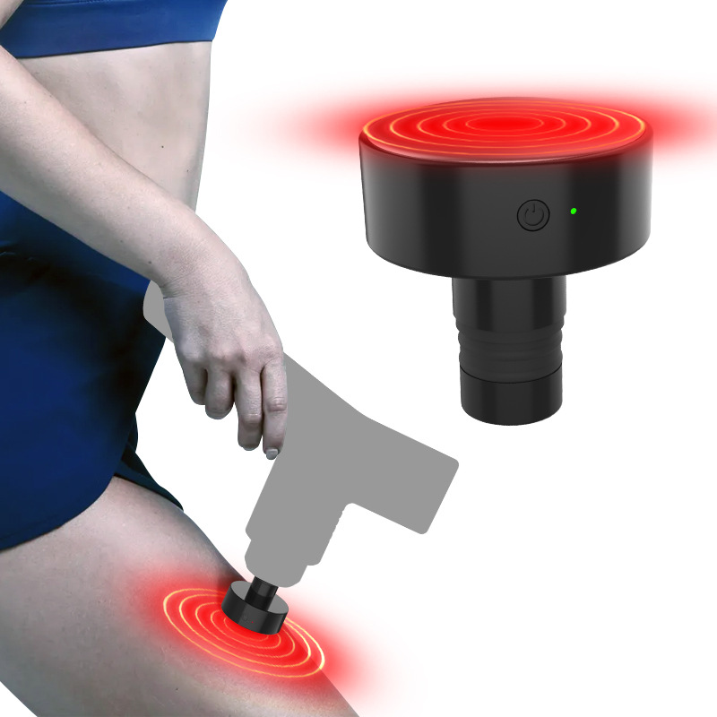 Heat head glowing red on a massage gun pressed to a thigh
