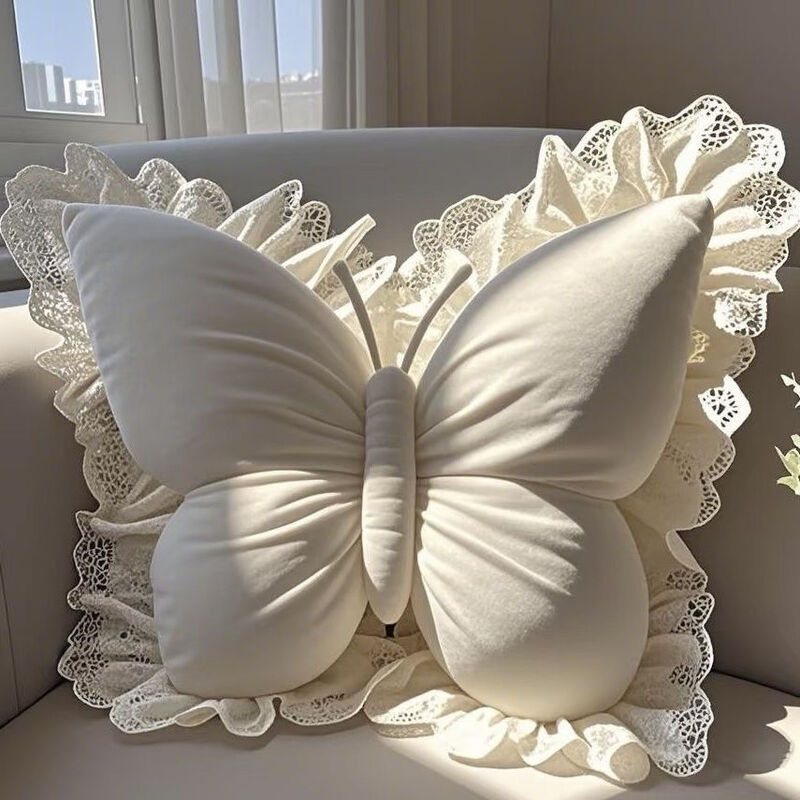 Velvet butterfly pillow placed on a sofa with a lace backdrop