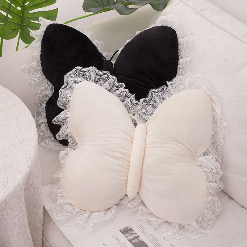 Butterfly throw pillow in a cozy bedroom corner with soft light