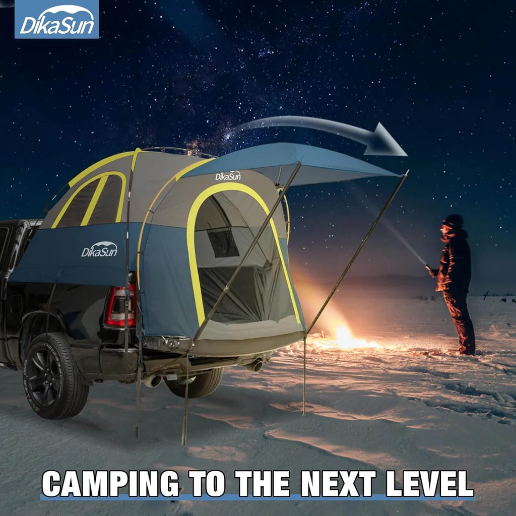 Truck bed tent interior set up with lantern light and camp gear