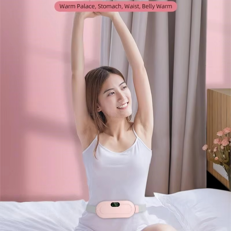 Woman curled in bed with a pink warm belt on her lower belly