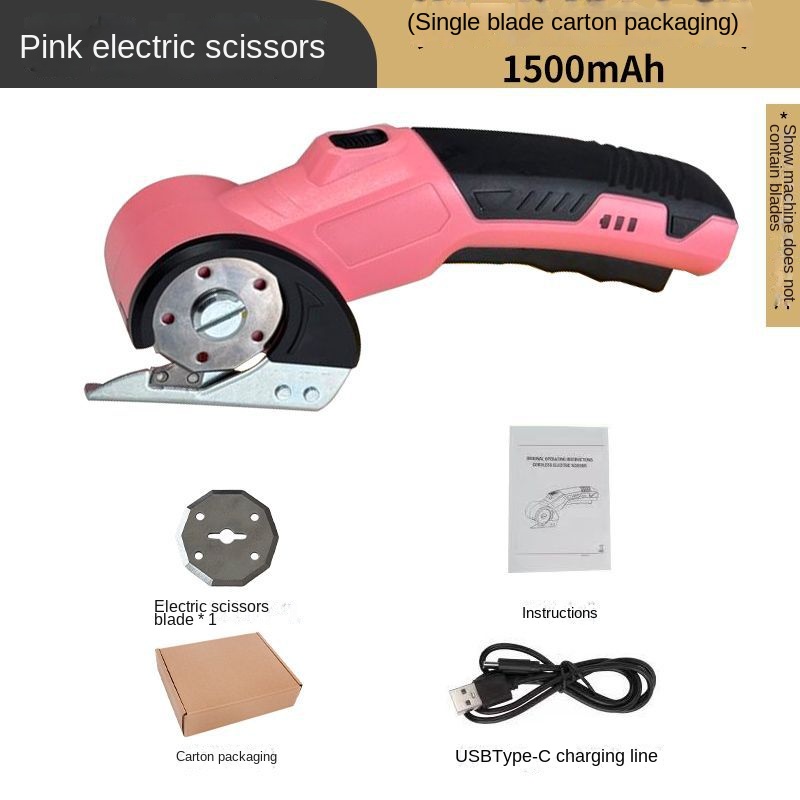 Cordless round-blade cutter resting beside fabric on a craft table