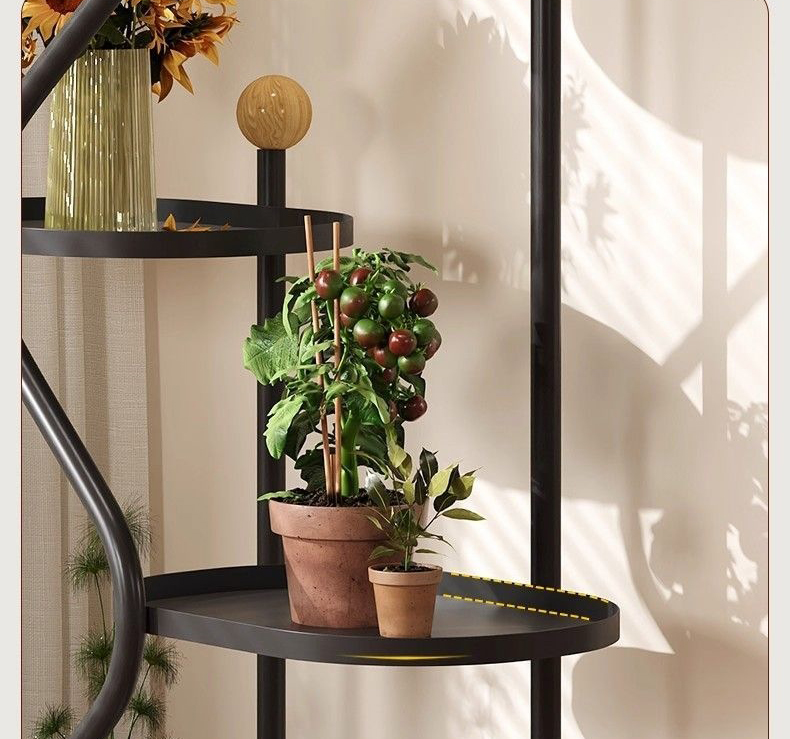 Lower round tray holding a potted tomato plant beside a small plant