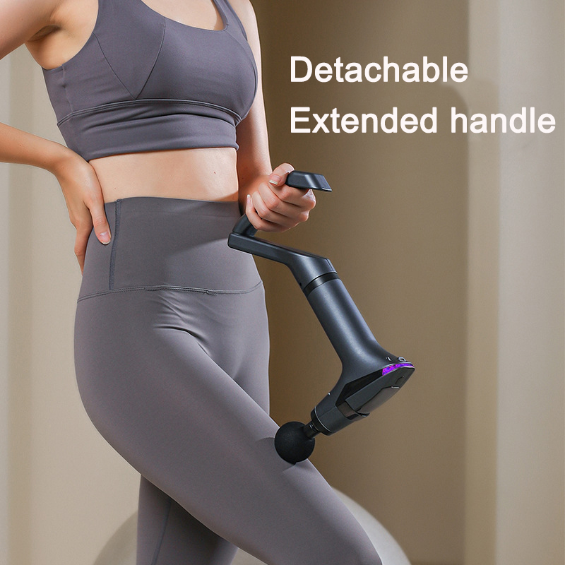 Woman working a massage gun on her thigh with extended handle attached