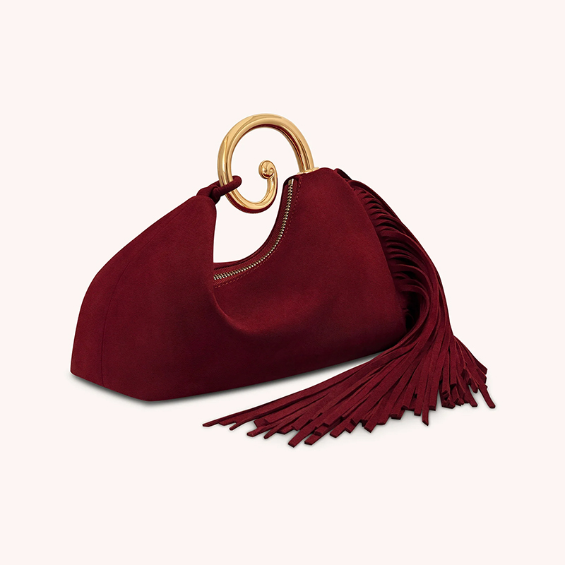 Burgundy suede handbag with gold zip pull and fringe, side angle