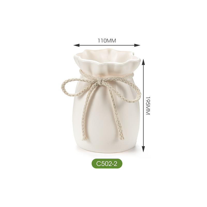 Matte white vase with braided cord bow shown at mid size