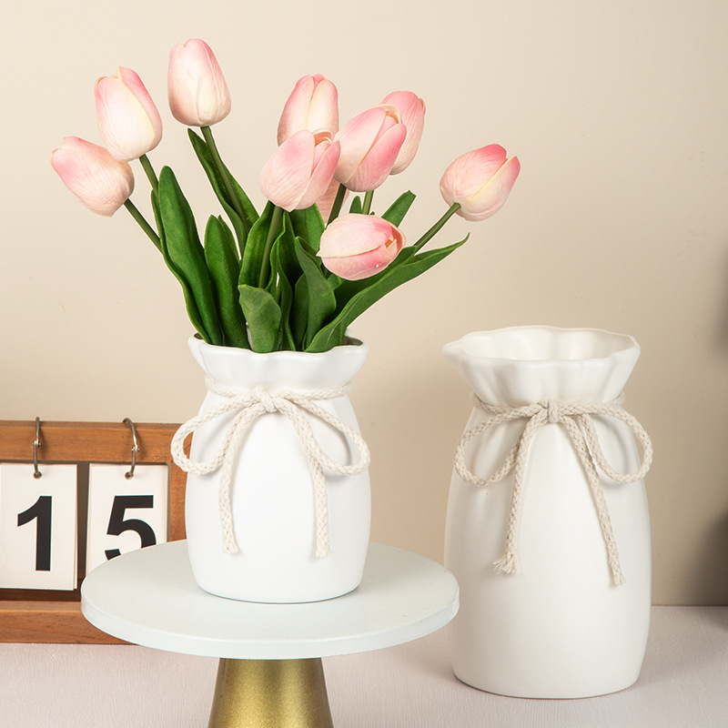Matte ivory vase surface in soft daylight, showing a quiet finish