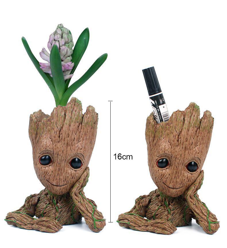 Baby Groot figure beside a hyacinth and a marker pen, height marked at 16 cm